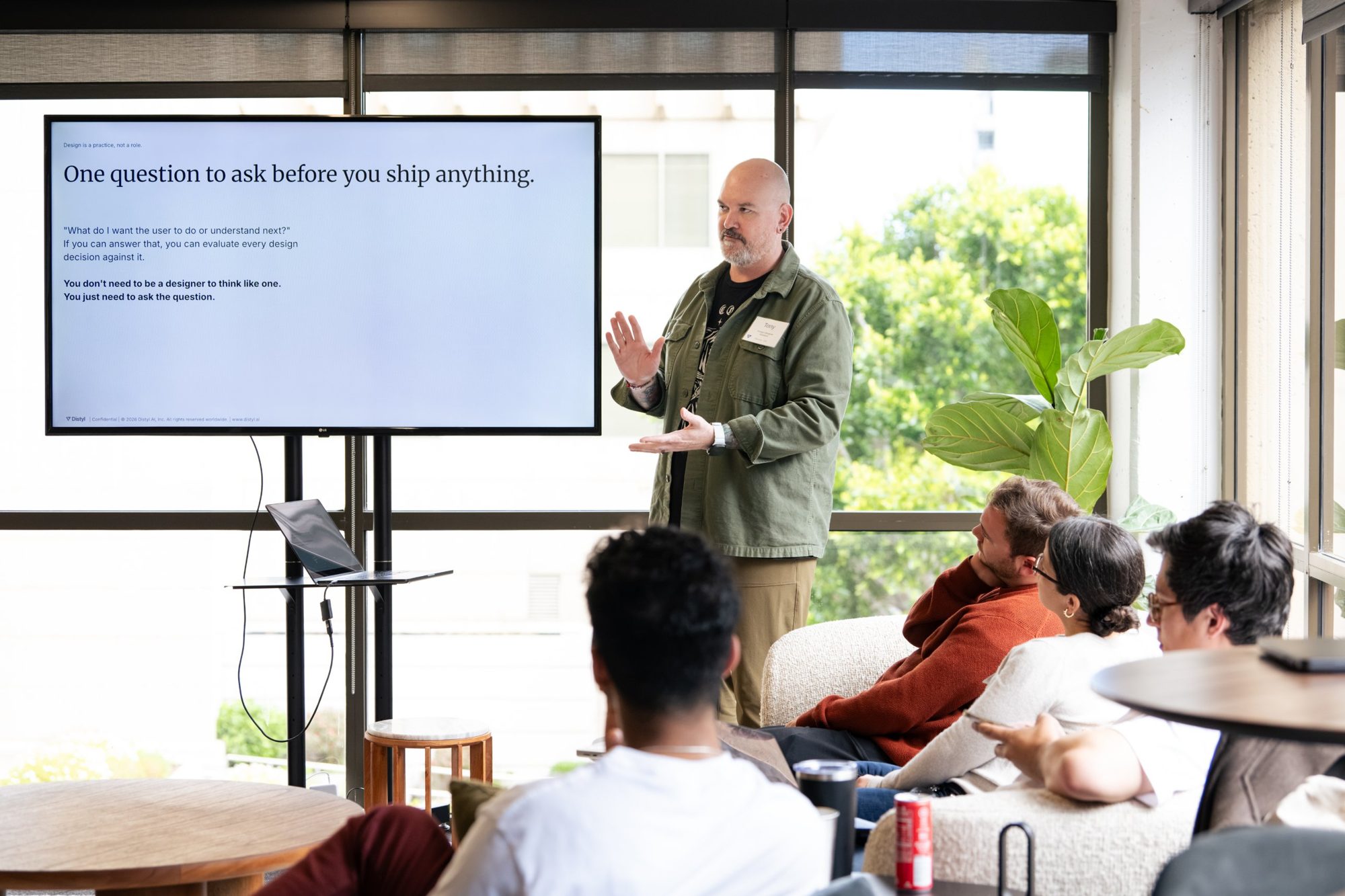Tony leading a design workshop beside a screen that reads: One question to ask before you ship anything