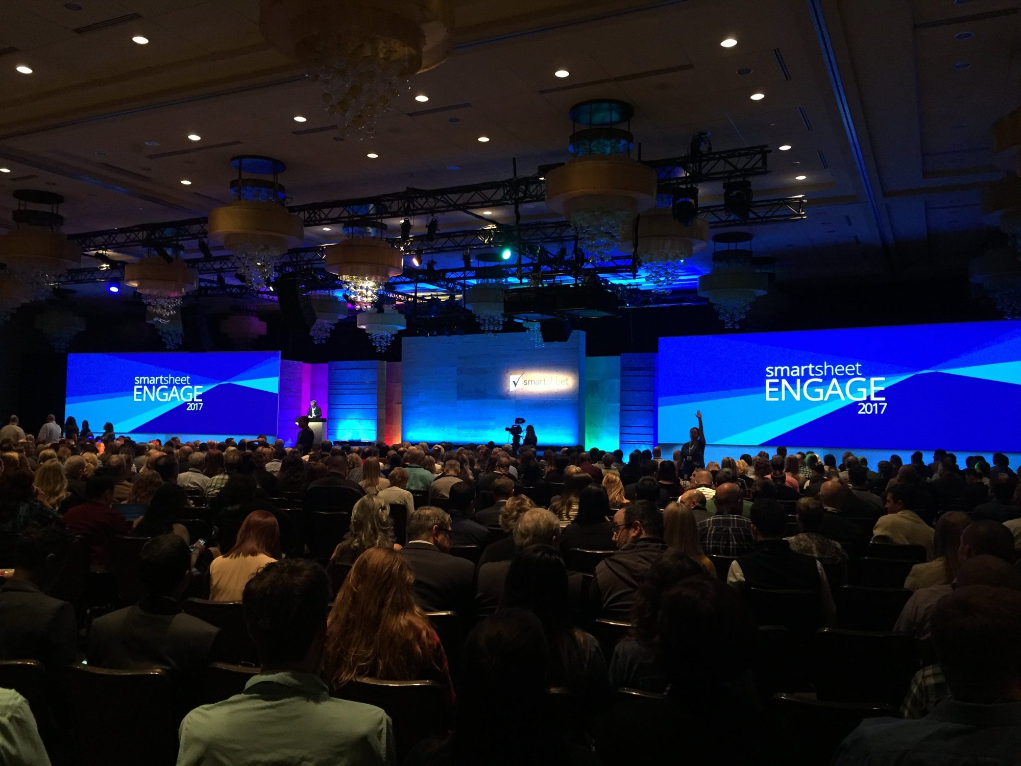 A packed ballroom facing the Engage 2017 keynote stage, with Smartsheet Engage on two giant blue screens