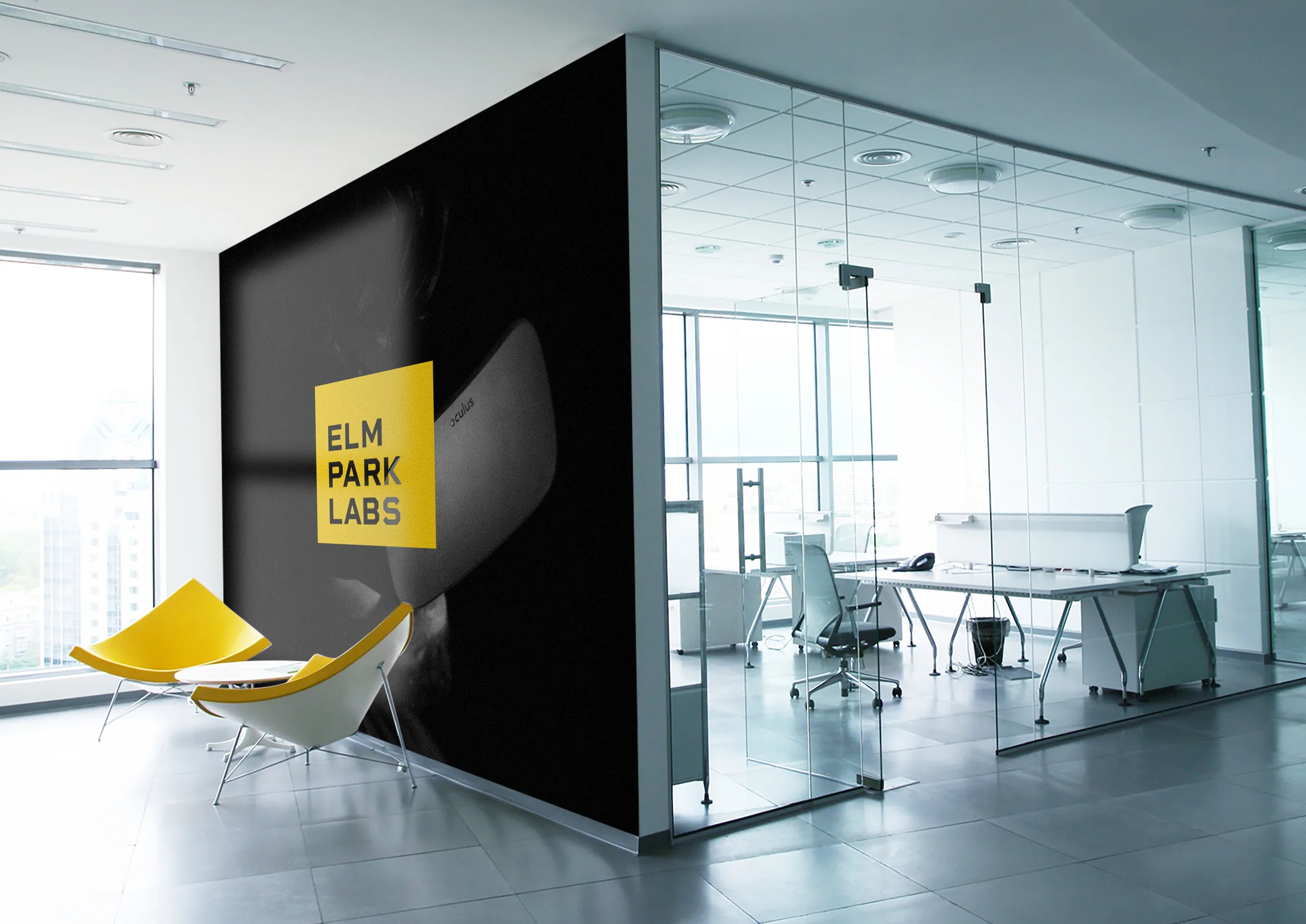 Office wall mural with the yellow Elm Park Labs mark over a VR headset photo