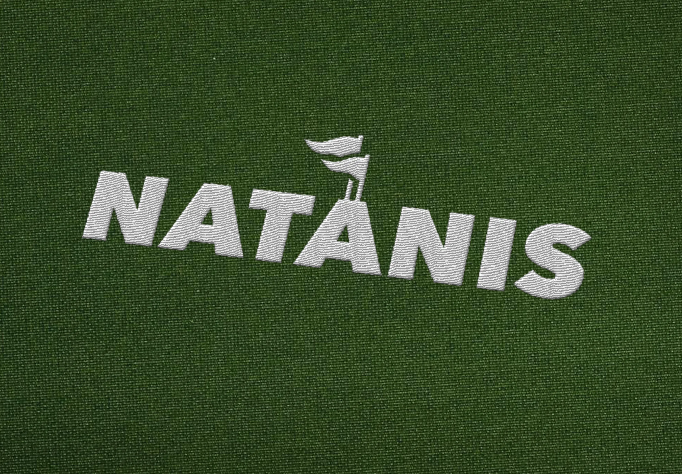 Natanis logo with two flags rising from the second A, embroidered in white on green fabric
