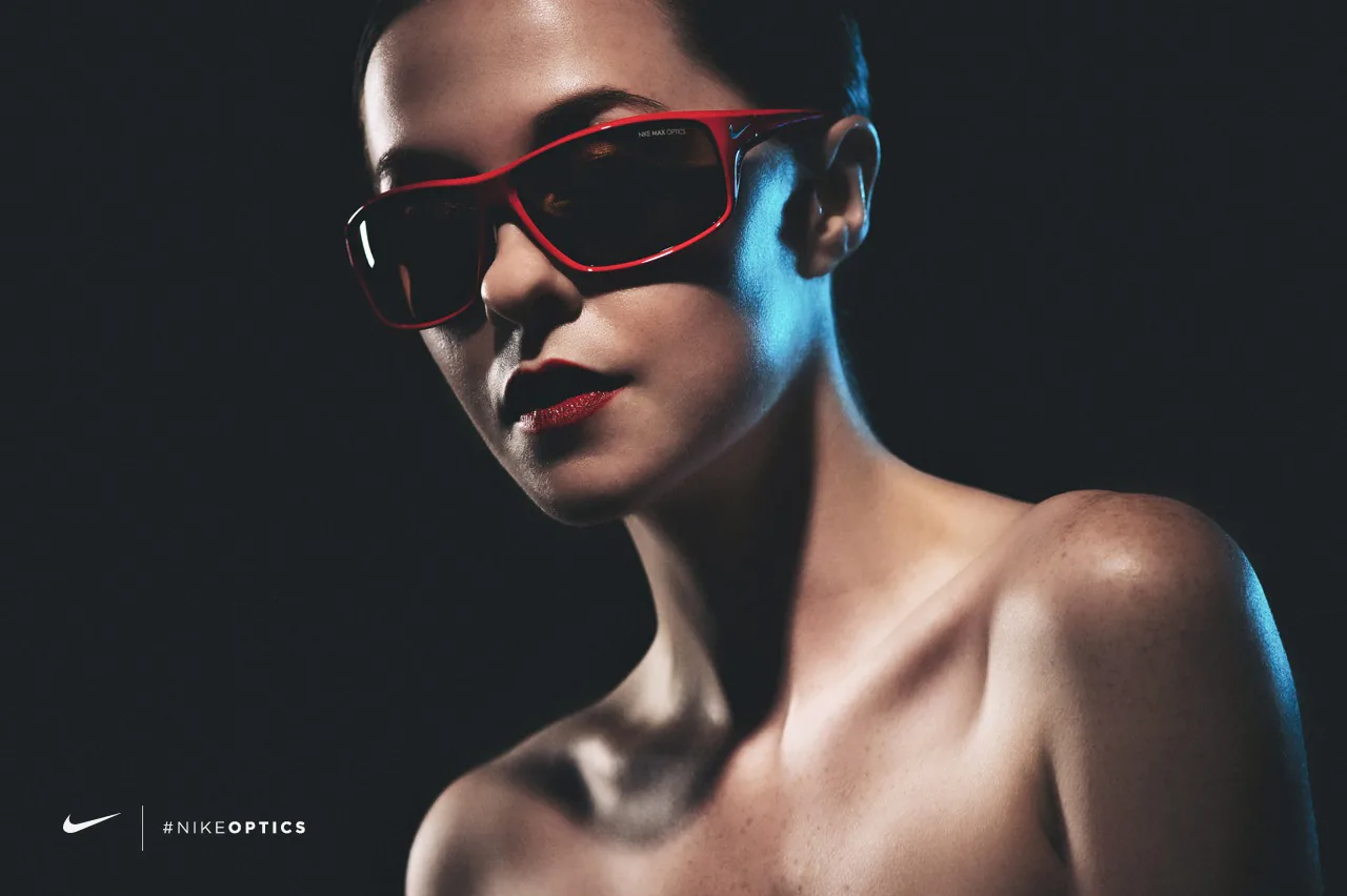 Studio portrait of a woman in red Nike Max Optics sunglasses